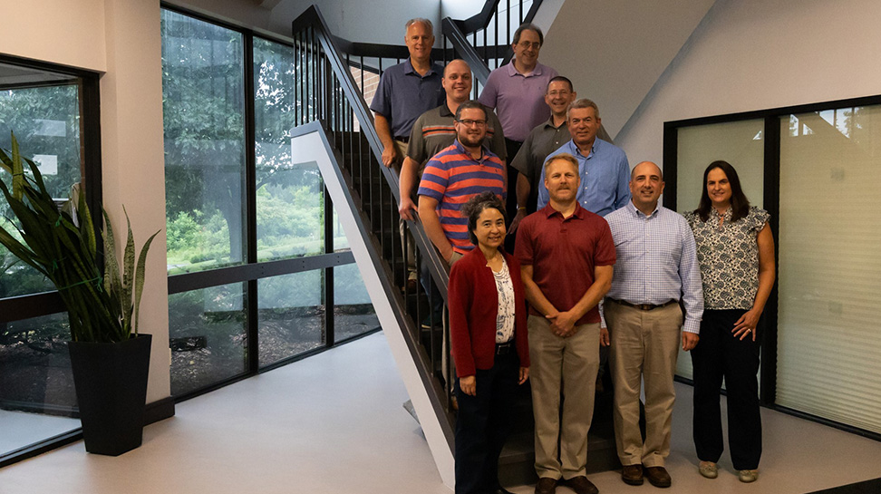 Team photo in front of stairway